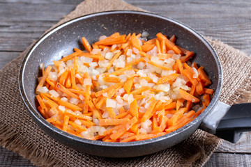 Fried onion and carrot with frying pan