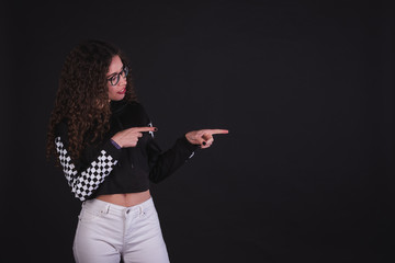 Young girl model posing with cute racing sweater in black background