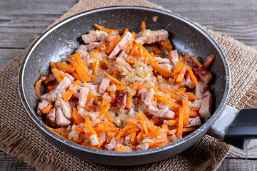 Fried onion and carrot with frying pan