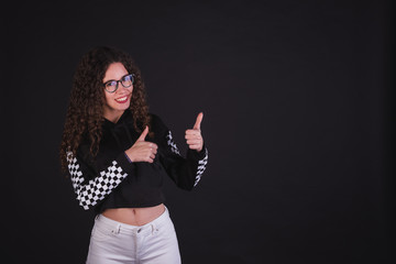 Young girl model posing with cute racing sweater in black background