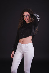 Young girl model posing with cute racing sweater in black background