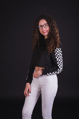 Young girl model posing with cute racing sweater in black background