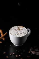 Cappuchino Coffee with chocolate dust on the top. black background