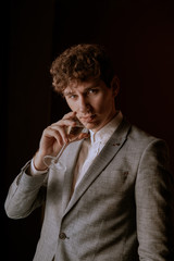 Content Handsome Entrepreneur with Glass of Wine looking in front of the camera