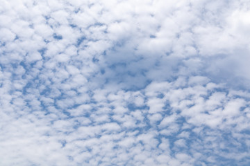 Fototapeta na wymiar Beautiful blue clear sky with white clouds background in sunny day and copy space. Nature bright sky background image. Summer blue sky. Texture for Design. Natural cloudy Wallpaper.
