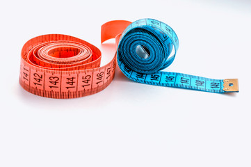 centimeter ribbon pink and blue on a white background. The concept of weight loss and a healthy...