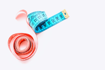 centimeter ribbon pink and blue on a white background. The concept of weight loss and a healthy...