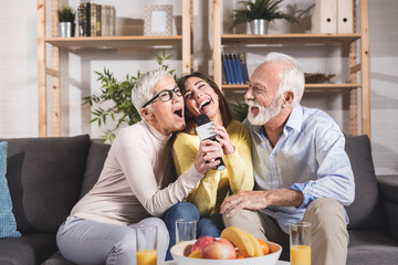 Beautiful family together. Mother, father and daughter smiling and hugging with love at home.