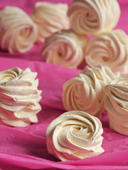 A freshly prepared delicious homemade apricot marshmallow (zephyr) located on a pink background. Vertical orientation. Selective focus on marshmallows.