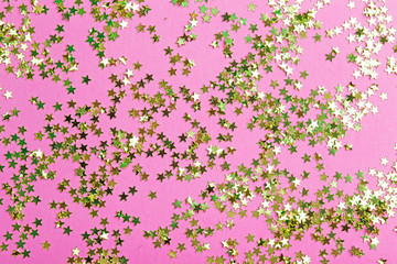 Gold glitter on a pink background. Celebration, party, birthday magic background. Creative minimal art concept