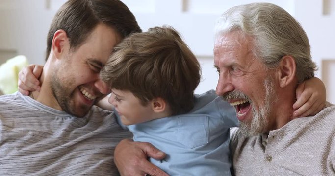 Cheerful intergenerational men family laughing hugging bonding, closeup portrait