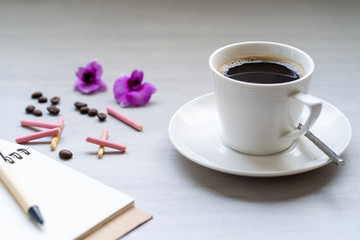 Cup coffee on white textured tile table.