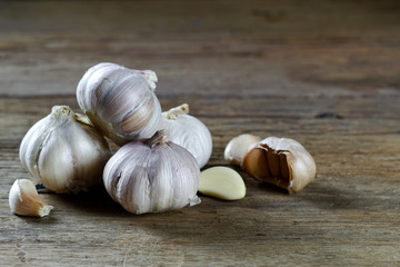 Fresh garlic and cloves on the wooden background