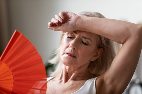 Close Up Of Senior Woman Suffering From Heatstroke At Home