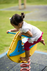 Cute little girl playing at playground.