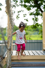Obraz premium Cute little girl playing at playground.