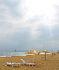 sandy beach with umbrellas, deck chairs. without people
