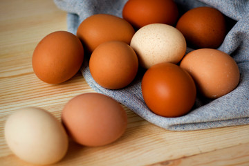 Whole and broken raw chicken eggs on a plate on a table yolk protein follows Easter eggs recipe food