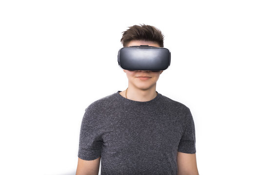 young guy in viar glasses. A teenager plays with virtual reality glasses. isolated on white background