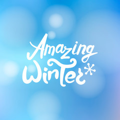 Amazing winter text calligraphy. Brush lettering at blurred winter background.
