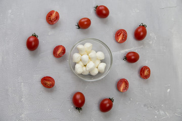 mozzarella and cherry tomatoes on a gray background