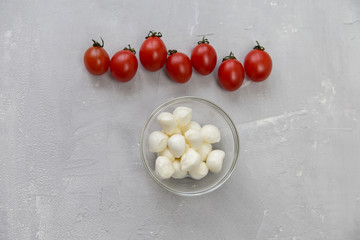 mozzarella and cherry tomatoes on a gray background