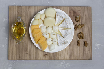  on a white plate lies assorted cheese appetizer different varieties