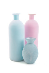 Blue and pink vases on white background