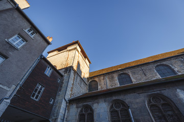 Fototapeta premium Old building corner with red tile roofs, traditional medieval French style buildings