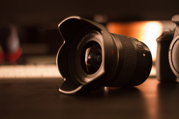 Camera and Lens on cozy Desk