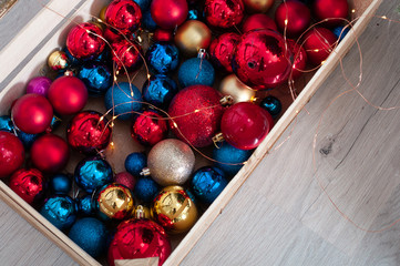 blue and red Christmas balls in a wooden box