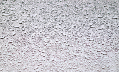 Waterdrops on grey surface.