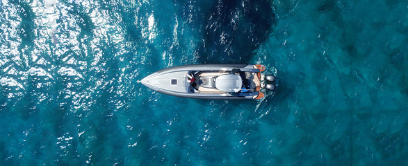 Aerial drone ultra wide photo of inflatable rib docked in tropical exotic bay