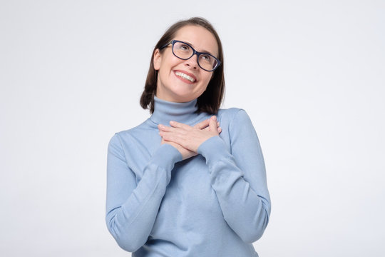 Female Coworker Keeps Hand On Chest As Being Satisfied To Hear Compliment From Stranger