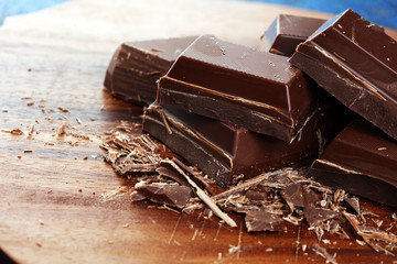 Dark chocolate stack, chips and powder with chocolate bars and block