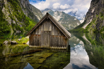 Wooden cabin surrounded by mountains in Lake Obersee