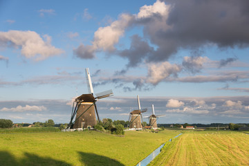 Three windmills in the countryside in the Netherlands