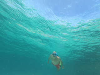 underwater man snorkeling in the sea withcrystal-clear waters concept of holiday relax summer beach...