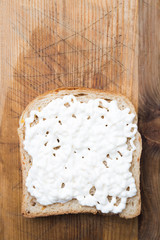 Slice of toast bread with mayonnaise spread