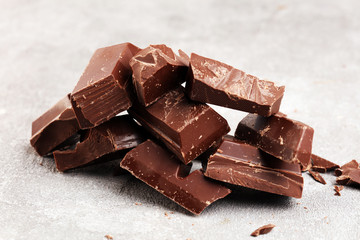 Dark chocolate stack, chips and powder with chocolate bars and block