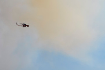Rescue helicopter puts out fires in the mountains and forest burning