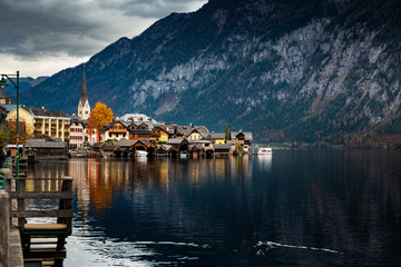 Hallstatter lake and Hallstatt village with blue sky in Austrian Alps / Evening light during autumn season / One of most popular tourist location in Austria