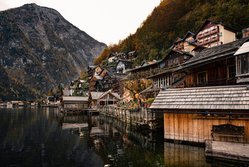 Hallstatter lake and Hallstatt village in Austrian Alps / Evening light during autumn season / One of most popular tourist location in Austria