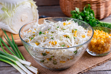 Chinese cabbage salad with sweet corn in a glass bowl