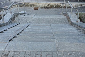gray old concrete steps on a large staircase of a city street