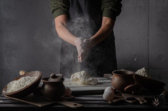 Thin graceful female hands a month dough. Dark Moody. - Powered by Adobe