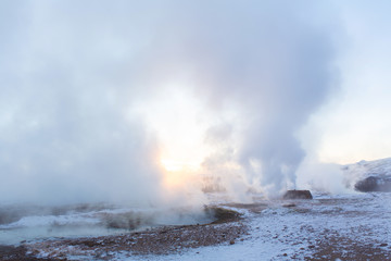 An erupting soaring geyser in the Valley of Geysers. Magnificent Iceland in the winter.