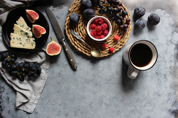 Cheese plate with grapes, figs and berry. Wine snaks. Top view with copy space. Flat lay concept.