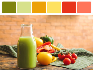 Bottle of fresh vegetable juice on table