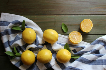 Pile of lemons on wooden table. Flat lay concept.